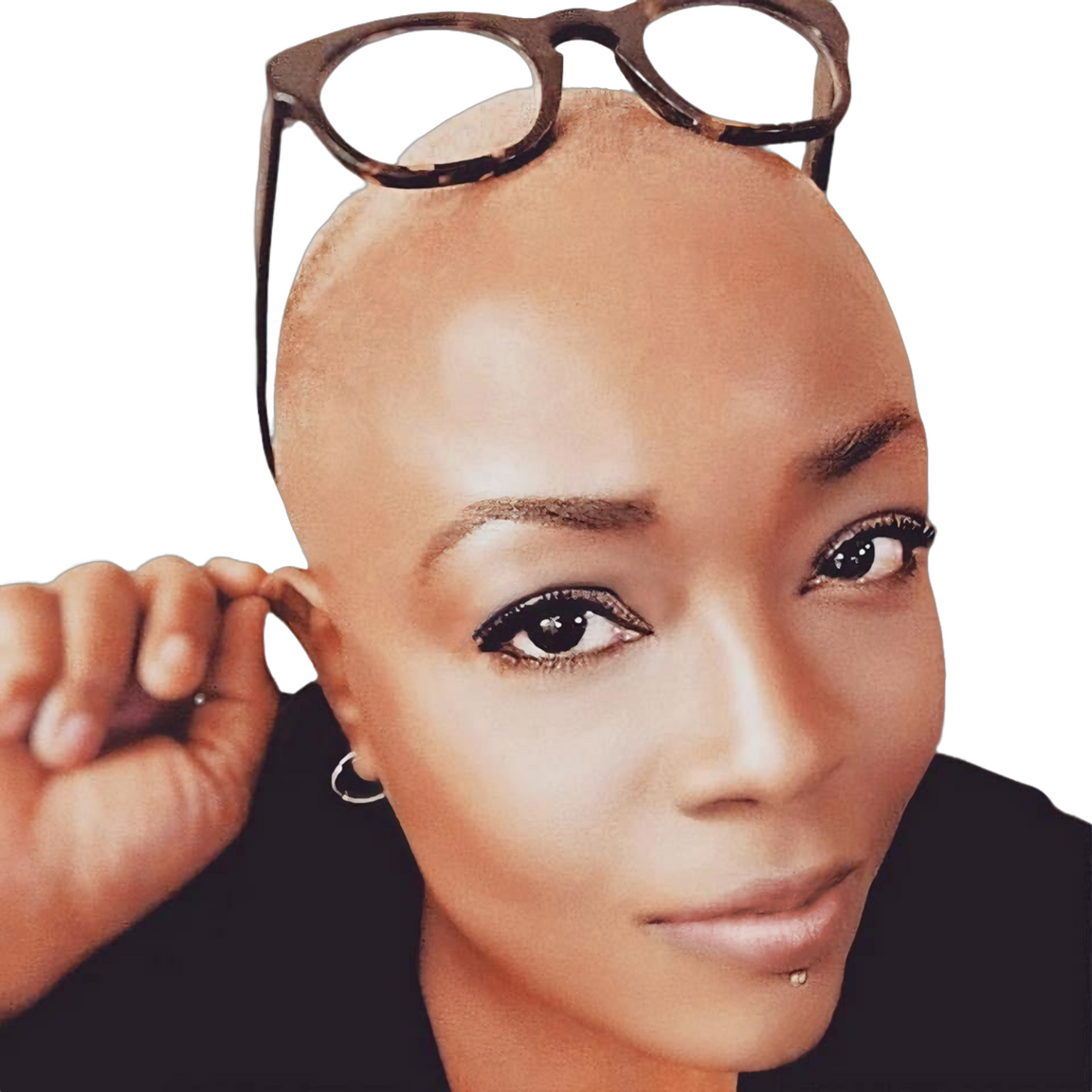 Close-up black and white portrait of Patsy Moore, a bald Black woman with glasses resting on her head, looking into the camera with a slight smile and a labret piercing below her bottom lip.